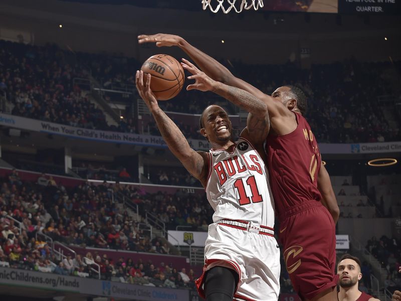 CLEVELAND, OH - FEBRUARY 14: DeMar DeRozan #11 of the Chicago Bulls drives to the basket against Evan Mobley #4 of the Cleveland Cavaliers during the game on February 14, 2024 at Rocket Mortgage FieldHouse in Cleveland, Ohio. NOTE TO USER: User expressly acknowledges and agrees that, by downloading and/or using this Photograph, user is consenting to the terms and conditions of the Getty Images License Agreement. Mandatory Copyright Notice: Copyright 2024 NBAE (Photo by David Liam Kyle/NBAE via Getty Images)