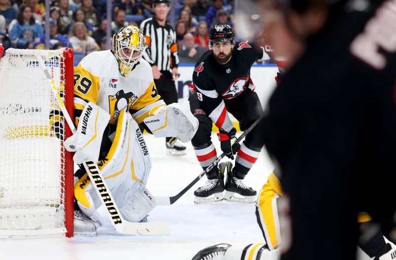 Jan 17, 2025; Buffalo, New York, USA;  Pittsburgh Penguins goaltender Alex Nedeljkovic (39) and Buffalo Sabres right wing Alex Tuch (89) look for the puck during the second period at KeyBank Center. Mandatory Credit: Timothy T. Ludwig-Imagn Images