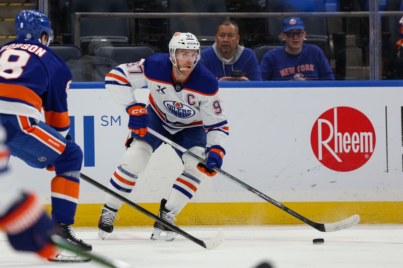 Mar 14, 2025; Elmont, New York, USA; Edmonton Oilers center Connor McDavid (97) controls the puck against the New York Islanders during the first period at UBS Arena. Mandatory Credit: Thomas Salus-Imagn Images