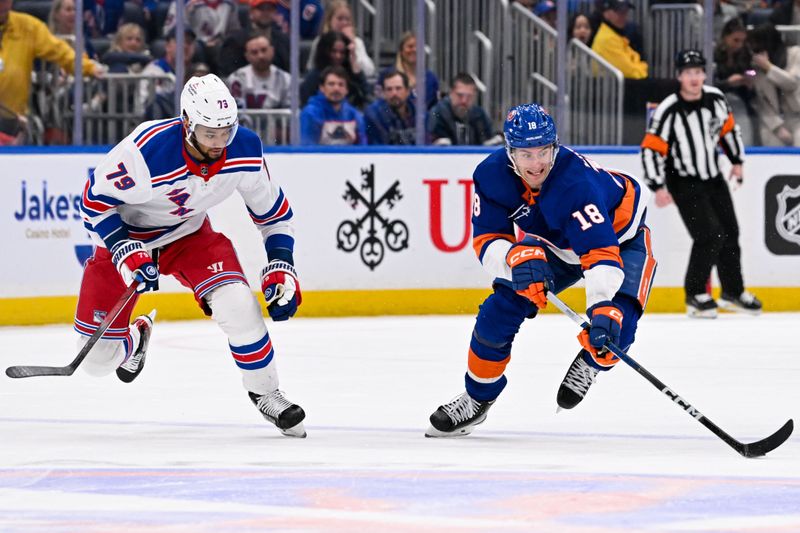 Apr 9, 2024; Elmont, New York, USA; New York Islanders left wing Pierre Engvall (18). Skates with the puck chased by New York Rangers defenseman K'Andre Miller (79) during the second period at UBS Arena. Mandatory Credit: Dennis Schneidler-USA TODAY Sports