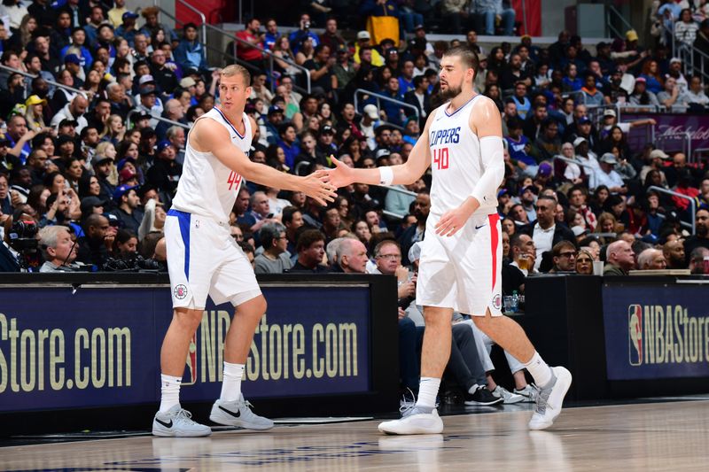 LOS ANGELES, CA - APRIL 4: Mason Plumlee #44 and Ivica Zubac #40 of the LA Clippers high five during the game against the Denver Nuggets on April 4, 2024 at Crypto.Com Arena in Los Angeles, California. NOTE TO USER: User expressly acknowledges and agrees that, by downloading and/or using this Photograph, user is consenting to the terms and conditions of the Getty Images License Agreement. Mandatory Copyright Notice: Copyright 2024 NBAE (Photo by Adam Pantozzi/NBAE via Getty Images)