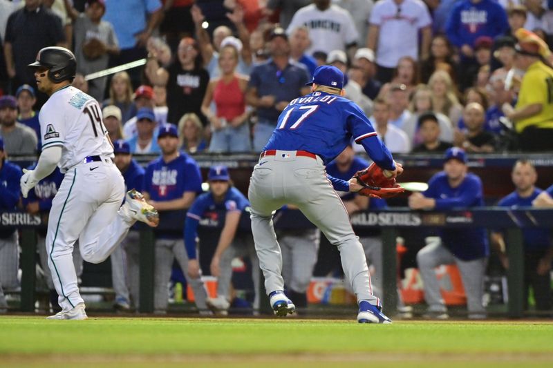 Nov 1, 2023; Phoenix, AZ, USA; Texas Rangers starting pitcher Nathan Eovaldi (17) fields a bunt hit by Arizona Diamondbacks catcher Gabriel Moreno (14) in the third inning in game five of the 2023 World Series at Chase Field. Mandatory Credit: Matt Kartozian-USA TODAY Sports