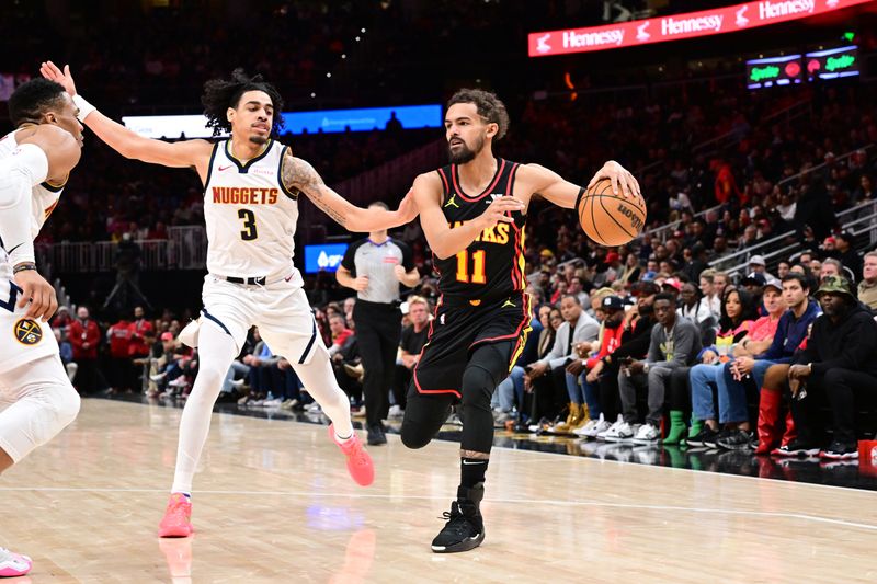 ATLANTA, GA - DECEMBER 8: Trae Young #11 of the Atlanta Hawks dribbles the ball during the game against the Denver Nuggets on December 8, 2024 at State Farm Arena in Atlanta, Georgia.  NOTE TO USER: User expressly acknowledges and agrees that, by downloading and/or using this Photograph, user is consenting to the terms and conditions of the Getty Images License Agreement. Mandatory Copyright Notice: Copyright 2024 NBAE (Photo by Adam Hagy/NBAE via Getty Images)