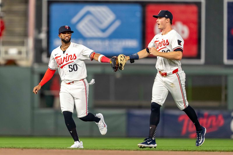 May 8, 2024; Minneapolis, Minnesota, USA; Minnesota Twins center fielder Willi Castro (50) celebrates with right fielder Max Kepler (26) after defeating the Seattle Mariners at Target Field. Mandatory Credit: Jesse Johnson-USA TODAY Sports