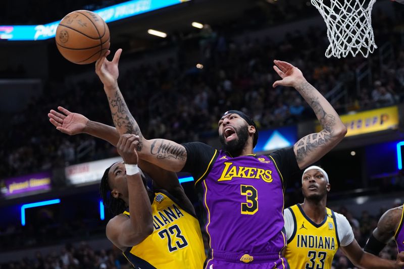 INDIANAPOLIS, INDIANA - MARCH 29: Aaron Nesmith #23 of the Indiana Pacers and Anthony Davis #3 of the Los Angeles Lakers battle for a rebound in the first quarter at Gainbridge Fieldhouse on March 29, 2024 in Indianapolis, Indiana. NOTE TO USER: User expressly acknowledges and agrees that, by downloading and or using this photograph, User is consenting to the terms and conditions of the Getty Images License Agreement. (Photo by Dylan Buell/Getty Images)