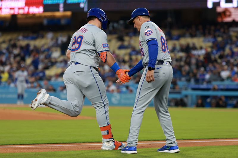 Apr 19, 2024; Los Angeles, California, USA;  New York Mets designated hitter DJ Stewart (29) is greeted by third base coach Mike Sarbaugh (88) after hitting a home run during the second inning against the Los Angeles Dodgers at Dodger Stadium. Mandatory Credit: Kiyoshi Mio-USA TODAY Sports
