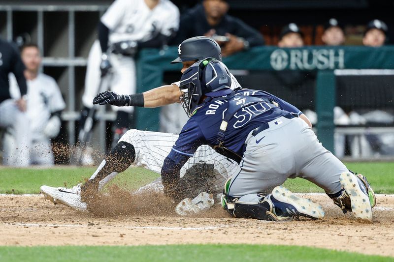 Apr 27, 2024; Chicago, Illinois, USA; Chicago White Sox left fielder Tommy Pham (28) scores against Tampa Bay Rays catcher Ben Rortvedt (30) during the fifth inning at Guaranteed Rate Field. Mandatory Credit: Kamil Krzaczynski-USA TODAY Sports