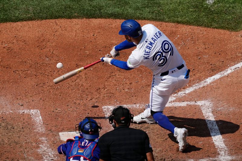 Jul 28, 2024; Toronto, Ontario, CAN; Toronto Blue Jays center fielder Kevin Kiermaier (39) hits a single against the Texas Rangers  during the sixth inning at Rogers Centre. Mandatory Credit: John E. Sokolowski-USA TODAY Sports