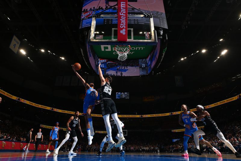 OKLAHOMA CITY, OK - APRIL 10:  Aaron Wiggins #21 of the Oklahoma City Thunder drives to the basket during the game against the San Antonio Spurs on April 10, 2024 at Paycom Arena in Oklahoma City, Oklahoma. NOTE TO USER: User expressly acknowledges and agrees that, by downloading and or using this photograph, User is consenting to the terms and conditions of the Getty Images License Agreement. Mandatory Copyright Notice: Copyright 2024 NBAE (Photo by Zach Beeker/NBAE via Getty Images)