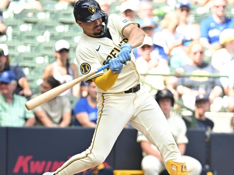 Jun 12, 2024; Milwaukee, Wisconsin, USA; Milwaukee Brewers shortstop Willy Adames (27) hits a home run against the Toronto Blue Jays in the sixth inning at American Family Field. Mandatory Credit: Michael McLoone-USA TODAY Sports