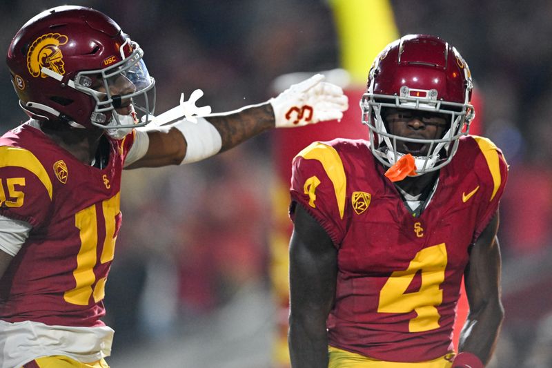 Nov 4, 2023; Los Angeles, California, USA; USC Trojans wide receiver Mario Williams (4) reacts with wide receiver Dorian Singer (15) after scoring against the Washington Huskies during the third quarter at United Airlines Field at Los Angeles Memorial Coliseum. Mandatory Credit: Jonathan Hui-USA TODAY Sports