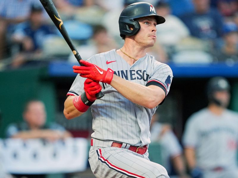 Jul 28, 2023; Kansas City, Missouri, USA; Minnesota Twins right fielder Max Kepler (26) hits a double during the fourth inning against the Kansas City Royals at Kauffman Stadium. Mandatory Credit: Jay Biggerstaff-USA TODAY Sports