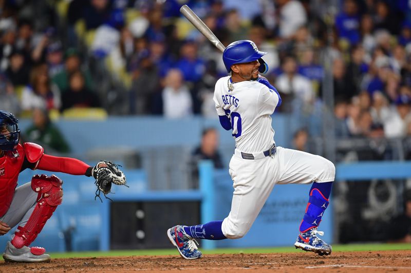 Apr 16, 2024; Los Angeles, California, USA; Los Angeles Dodgers shortstop Mookie Betts (50) hits a double against the Washington Nationals during the seventh inning at Dodger Stadium. Mandatory Credit: Gary A. Vasquez-USA TODAY Sports