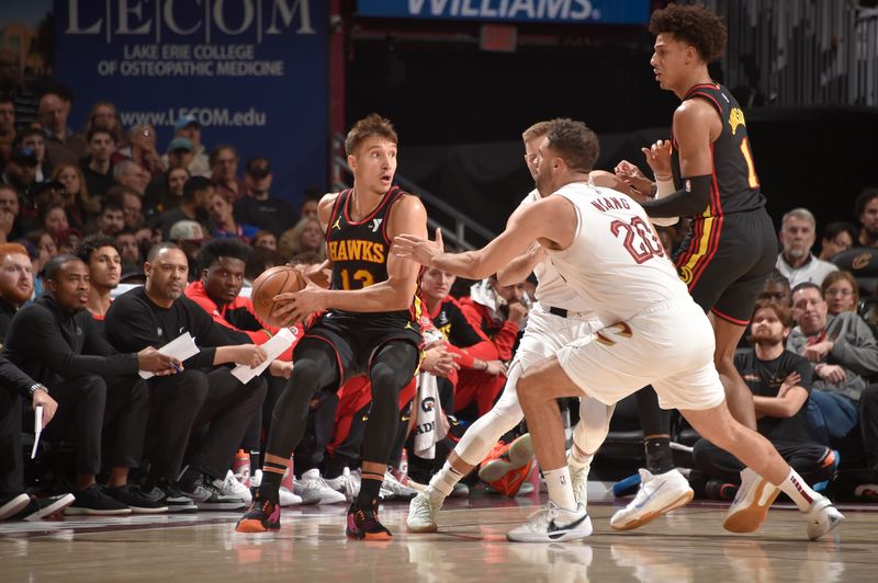 CLEVELAND, OH - NOVEMBER 27: Bogdan Bogdanovic #13 of the Atlanta Hawks handles the ball during the game against the Cleveland Cavaliers on November 27, 2024 at Rocket Mortgage FieldHouse in Cleveland, Ohio. NOTE TO USER: User expressly acknowledges and agrees that, by downloading and/or using this Photograph, user is consenting to the terms and conditions of the Getty Images License Agreement. Mandatory Copyright Notice: Copyright 2024 NBAE (Photo by David Liam Kyle/NBAE via Getty Images)