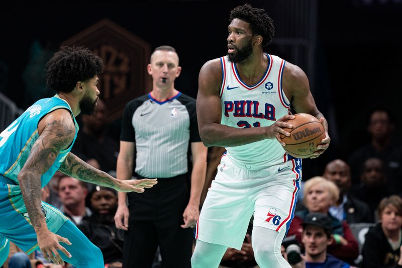 CHARLOTTE, NORTH CAROLINA - DECEMBER 16: Nick Richards #4 of the Charlotte Hornets guards Joel Embiid #21 of the Philadelphia 76ers in the first quarter during their game at Spectrum Center on December 16, 2023 in Charlotte, North Carolina. NOTE TO USER: User expressly acknowledges and agrees that, by downloading and or using this photograph, User is consenting to the terms and conditions of the Getty Images License Agreement. (Photo by Jacob Kupferman/Getty Images)