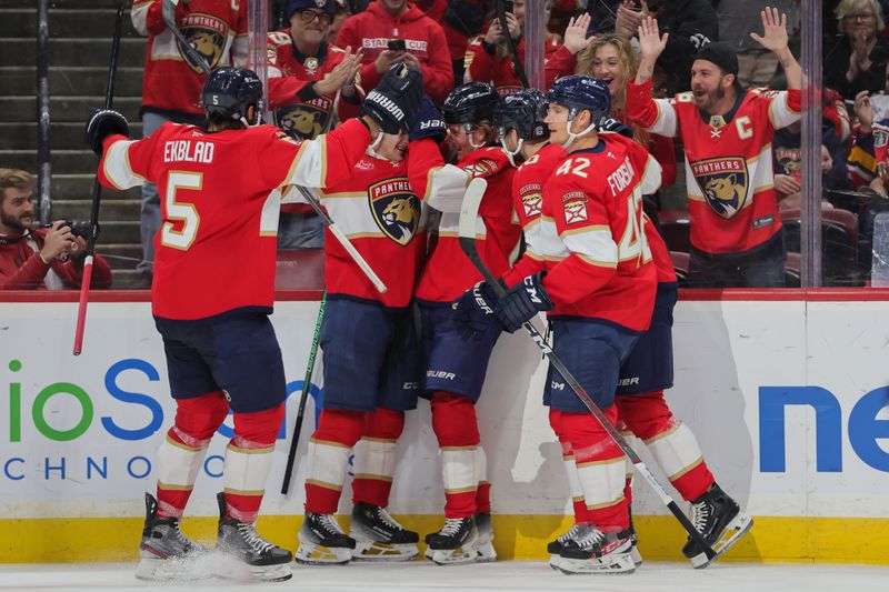 Oct 17, 2024; Sunrise, Florida, USA; Florida Panthers center Jesper Boqvist (70) celebrates with teammates after scoring against the Vancouver Canucks during the first period at Amerant Bank Arena. Mandatory Credit: Sam Navarro-Imagn Images