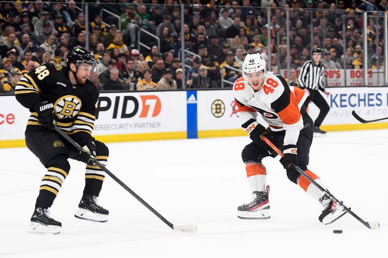 Mar 16, 2024; Boston, Massachusetts, USA; Philadelphia Flyers center Morgan Frost (48) controls the puck while Boston Bruins defenseman Matt Grzelcyk (48) defends during the second period at TD Garden. Mandatory Credit: Bob DeChiara-USA TODAY Sports