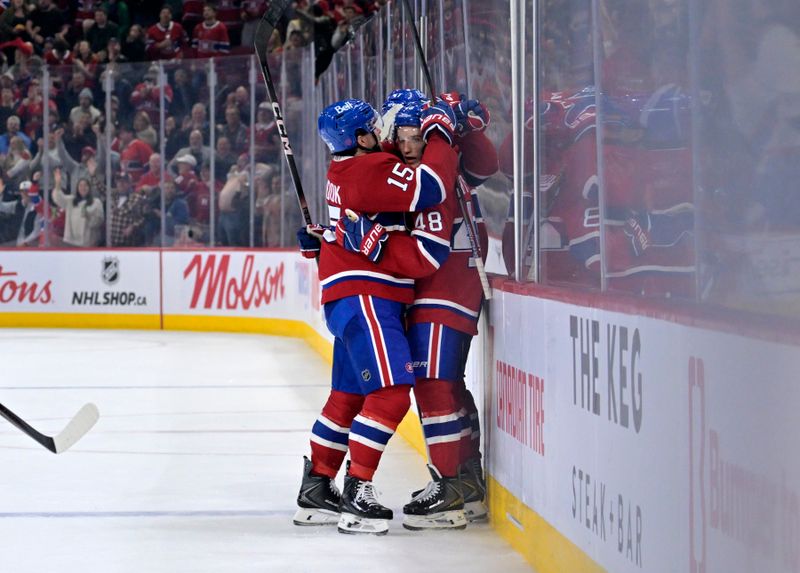 Oct 20, 2025; Montreal, Quebec, CAN; Montreal Canadiens defenseman Lane Hutson (48) celebrates with teammate  forward Alex Newhook (15) after scoring a goal against the Buffalo Sabres during the third period at the Bell Centre. Mandatory Credit: Eric Bolte-Imagn Images