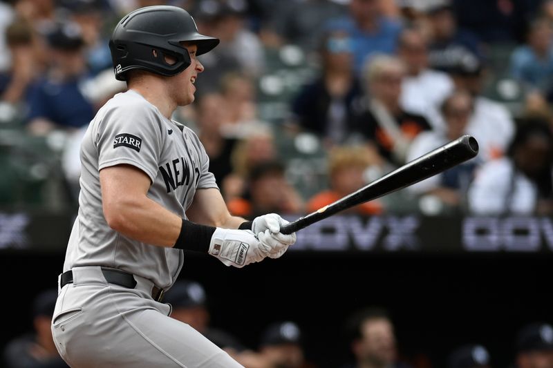 Sep 21, 2025; Baltimore, Maryland, USA;  New York Yankees first base Ben Rice (22) swings through sixth inning rbi single against the Baltimore Orioles at Oriole Park at Camden Yards. Mandatory Credit: Tommy Gilligan-Imagn Images