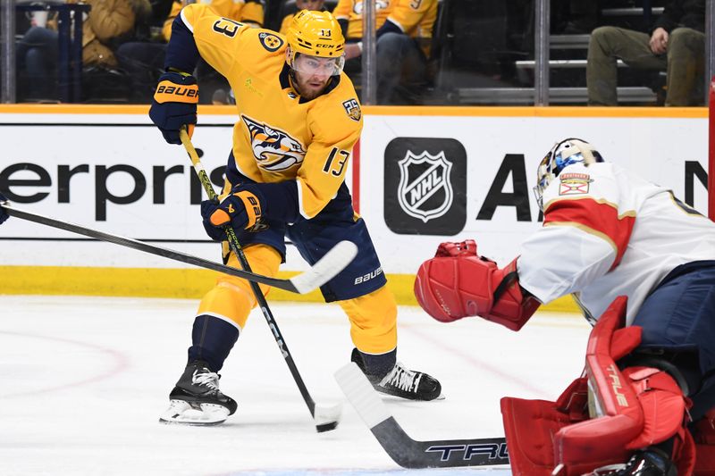 Jan 22, 2024; Nashville, Tennessee, USA; Nashville Predators center Yakov Trenin (13) shoots the puck against Florida Panthers goaltender Anthony Stolarz (41) during the first period at Bridgestone Arena. Mandatory Credit: Christopher Hanewinckel-USA TODAY Sports