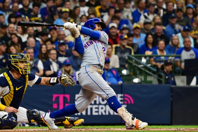 Oct 3, 2024; Milwaukee, Wisconsin, USA; New York Mets shortstop Francisco Lindor (12) hits a single against Milwaukee Brewers in the third inning during game three of the Wildcard round for the 2024 MLB Playoffs at American Family Field. Mandatory Credit: Benny Sieu-Imagn Images