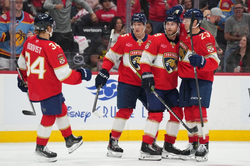 Oct 19, 2024; Sunrise, Florida, USA;  Florida Panthers center Sam Bennett (9) celebrates with teammates after a goal against the Vegas Golden Knights during the second period at Amerant Bank Arena. Mandatory Credit: Jim Rassol-Imagn Images