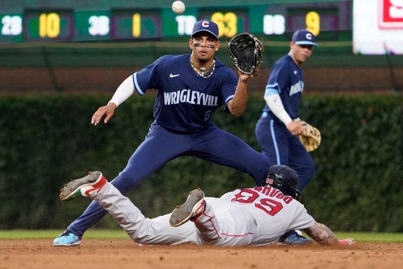 Jul 14, 2023; Chicago, Illinois, USA; Boston Red Sox right fielder Alex Verdugo (99) steals second base as Chicago Cubs second baseman Christopher Morel (5) takes a late throw during the third inning at Wrigley Field. Mandatory Credit: David Banks-USA TODAY Sports