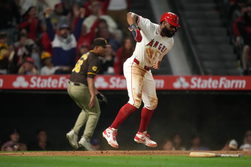 Jun 3, 2024; Anaheim, California, USA; Los Angeles Angels right fielder Jo Adell (7) celebrates after scoring in the eight inning against the San Diego Padres at Angel Stadium. Mandatory Credit: Kirby Lee-USA TODAY Sports