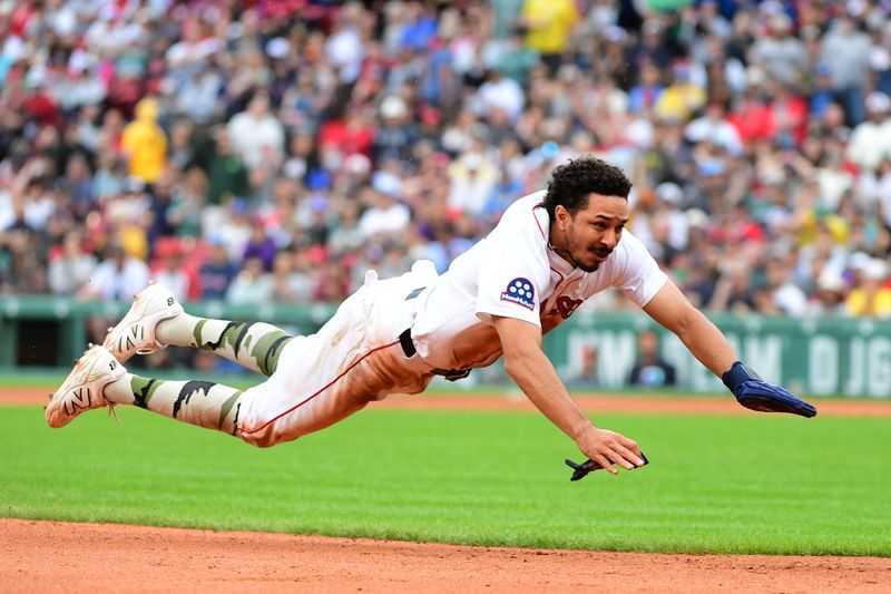 May 18, 2025; Boston, Massachusetts, USA;  Boston Red Sox second baseman David Hamilton (17) dives into third base during the fourth inning against the Atlanta Braves at Fenway Park. Mandatory Credit: Bob DeChiara-Imagn Images