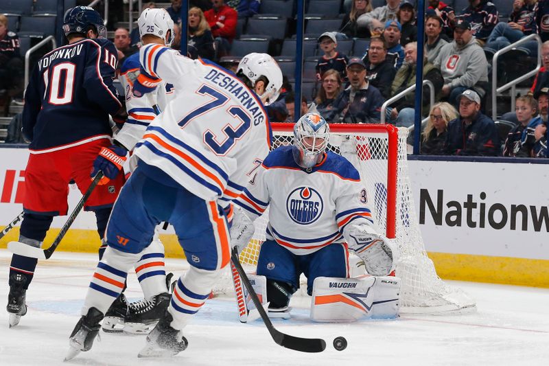 Mar 7, 2024; Columbus, Ohio, USA; Edmonton Oilers defenseman Vincent Desharnais (73) clears the rebound of a goalie Calvin Pickard (30) during the first period against the Columbus Blue Jackets at Nationwide Arena. Mandatory Credit: Russell LaBounty-USA TODAY Sports