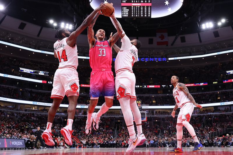 CHICAGO, ILLINOIS - FEBRUARY 26: Andre Drummond #3 and Patrick Williams #44 of the Chicago Bulls block a shot by Kyle Kuzma #33 of the Washington Wizards during the second half at United Center on February 26, 2023 in Chicago, Illinois. NOTE TO USER: User expressly acknowledges and agrees that, by downloading and or using this photograph, User is consenting to the terms and conditions of the Getty Images License Agreement.  (Photo by Michael Reaves/Getty Images)