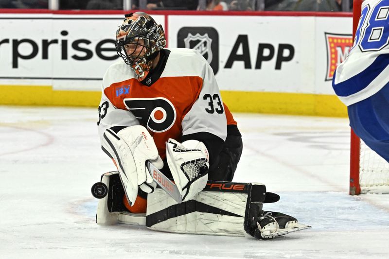 Jan 23, 2024; Philadelphia, Pennsylvania, USA; Philadelphia Flyers goaltender Samuel Ersson (33) clears the puck against the Tampa Bay Lightning during the second period at Wells Fargo Center. Mandatory Credit: Eric Hartline-USA TODAY Sports