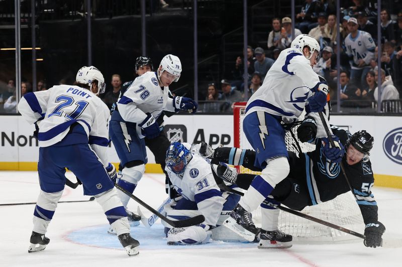 Nov 2, 2025; Salt Lake City, Utah, USA; Tampa Bay Lightning goaltender Jonas Johansson (31) covers the puck as Tampa Bay Lightning defenseman J.J. Moser (90) clears Utah Mammoth right wing Kailer Yamamoto (56) from the crease during the third period at Delta Center. Mandatory Credit: Rob Gray-Imagn Images