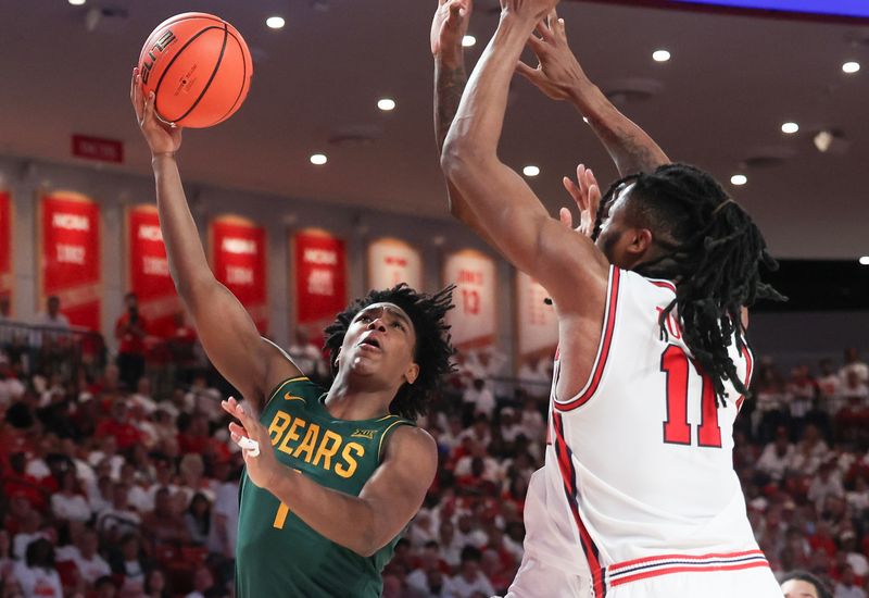 Feb 10, 2025; Houston, Texas, USA; Baylor Bears guard Robert Wright III (1) shoots against Houston Cougars forward Joseph Tugler (11) in the second half at Fertitta Center. Mandatory Credit: Thomas Shea-Imagn Images