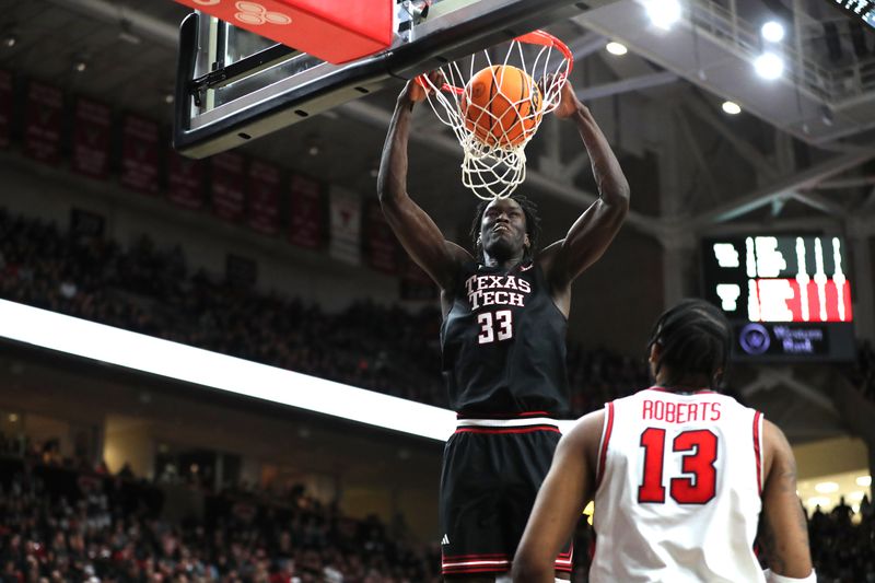 Feb 24, 2025; Lubbock, Texas, USA;  Texas Tech Red Raiders forward Federiko Federiko (33) slam dunks the ball against Houston Cougars forward J’Wan Roberts (13) in the second half at United Supermarkets Arena. Mandatory Credit: Michael C. Johnson-Imagn Images