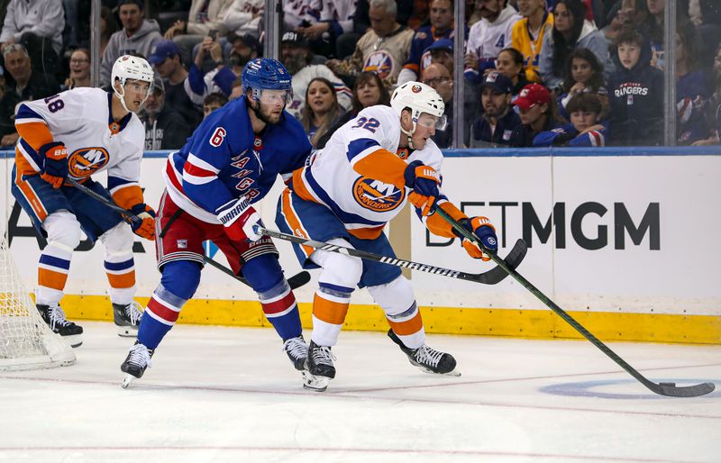 Sep 24, 2024; New York, New York, USA; New York Islanders center Kyle McLean (32) is defended by New York Rangers defenseman Zac Jones (6) during the second period at Madison Square Garden. Mandatory Credit: Danny Wild-Imagn Images