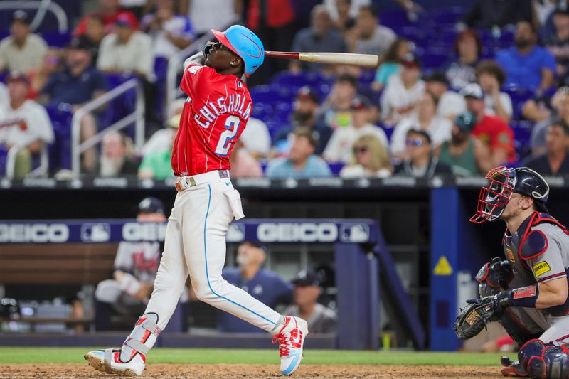 Sep 16, 2023; Miami, Florida, USA; Miami Marlins center fielder Jazz Chisholm Jr. (2) hits a grand slam against the Atlanta Braves during the eighth inning at loanDepot Park. Mandatory Credit: Sam Navarro-USA TODAY Sports