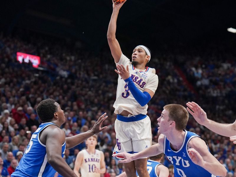 Feb 27, 2024; Lawrence, Kansas, USA; Kansas Jayhawks guard Dajuan Harris Jr. (3) shoots as Brigham Young Cougars forward Fousseyni Traore (45) defends during the second half at Allen Fieldhouse. Mandatory Credit: Denny Medley-USA TODAY Sports