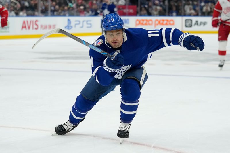 Nov 8, 2024; Toronto, Ontario, CAN; Toronto Maple Leafs forward Max Domi (11) skates against the Detroit Red Wings during the first period at Scotiabank Arena. Mandatory Credit: John E. Sokolowski-Imagn Images