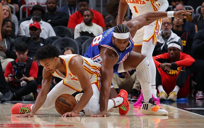 ATLANTA, GEORGIA - OCTOBER 14:  Guerschon Yabusele #28 of the Philadelphia 76ers reaches to steal the ball against Kobe Bufkin #4 of the Atlanta Hawks during the second quarter at State Farm Arena on October 14, 2024 in Atlanta, Georgia.  NOTE TO USER: User expressly acknowledges and agrees that, by downloading and/or using this photograph, user is consenting to the terms and conditions of the Getty Images License Agreement.  (Photo by Kevin C. Cox/Getty Images)