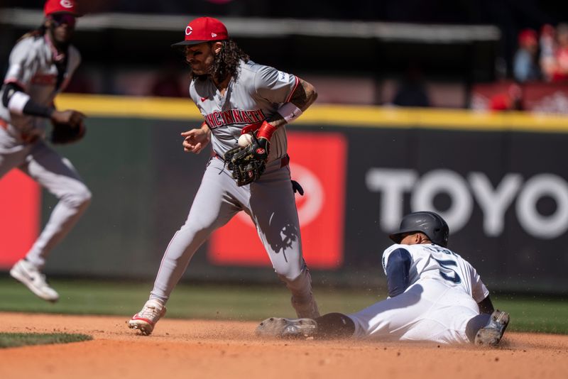 Apr 17, 2024; Seattle, Washington, USA; Seattle Mariners left fielder Jonatan Clase steals second base before Cincinnati Reds second baseman can put on a tag during the seventh inning at T-Mobile Park. Mandatory Credit: Stephen Brashear-USA TODAY Sports