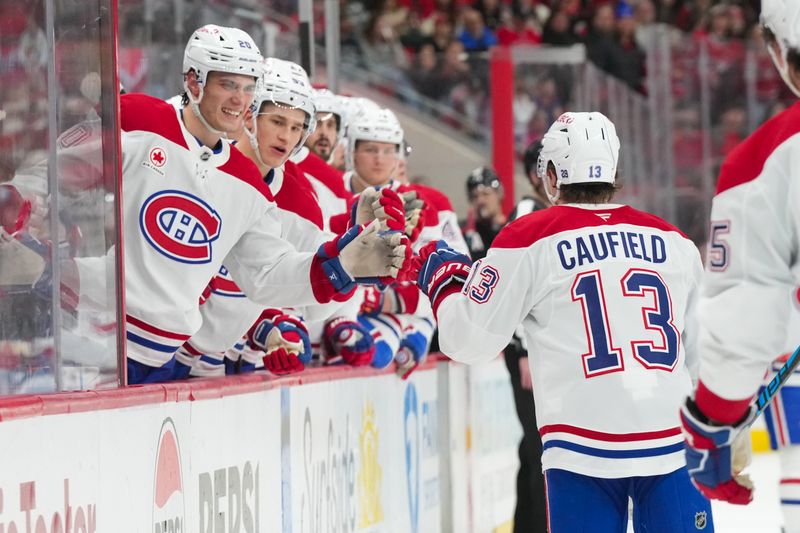 Jan 1, 2026; Raleigh, North Carolina, USA;  Montréal Canadiens right wing Cole Caufield (13) celebrates his goal against the Carolina Hurricanes during the second period at Lenovo Center. Mandatory Credit: James Guillory-Imagn Images