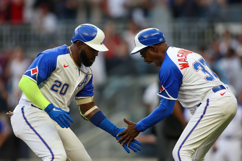 May 6, 2023; Atlanta, Georgia, USA; Atlanta Braves designated hitter Marcell Ozuna (20) celebrates after a home run with third base coach Ron Washington (37) against the Baltimore Orioles in the third inning at Truist Park. Mandatory Credit: Brett Davis-USA TODAY Sports