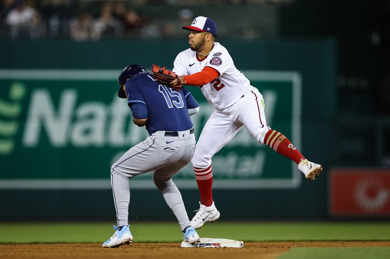 Apr 3, 2023; Washington, District of Columbia, USA; Tampa Bay Rays right fielder Josh Lowe (15) reaches second safely after a throwing error by Washington Nationals relief pitcher Anthony Banda (50) to second baseman Luis Garcia (2) during the ninth inning at Nationals Park. Mandatory Credit: Scott Taetsch-USA TODAY Sports