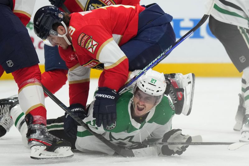 Dec 6, 2023; Sunrise, Florida, USA; Florida Panthers left wing Matthew Tkachuk (19) collides with Dallas Stars left wing Mason Marchment (27) during the first period at Amerant Bank Arena. Mandatory Credit: Jim Rassol-USA TODAY Sports