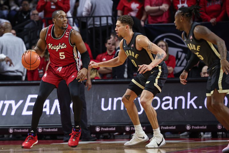 Jan 28, 2024; Piscataway, New Jersey, USA; Rutgers Scarlet Knights forward Aundre Hyatt (5) dribbles against Purdue Boilermakers forward Mason Gillis (0) during the first half at Jersey Mike's Arena. Mandatory Credit: Vincent Carchietta-USA TODAY Sports