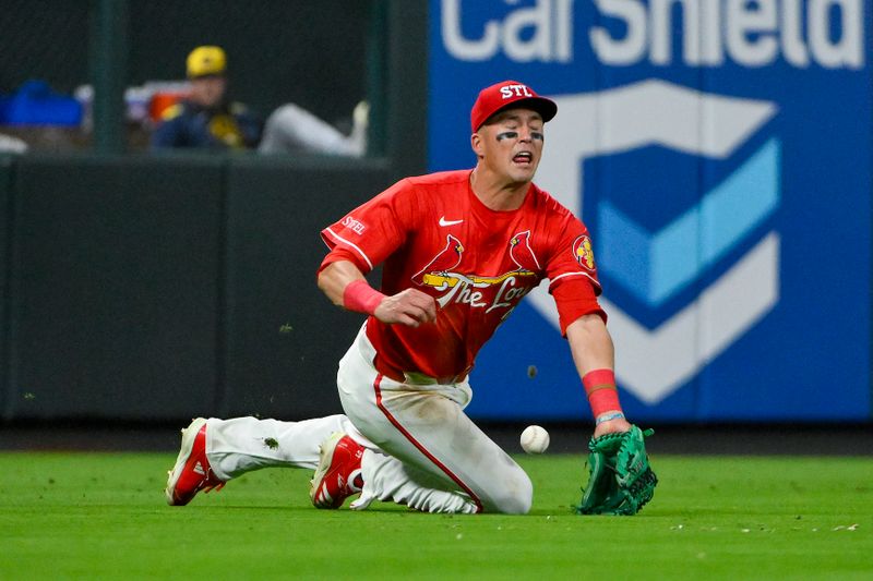 Apr 25, 2025; St. Louis, Missouri, USA;  St. Louis Cardinals left fielder Lars Nootbaar (21) dives but is unable to field a double hit by Milwaukee Brewers right fielder Sal Frelick (not pictured) during the seventh inning at Busch Stadium. Mandatory Credit: Jeff Curry-Imagn Images