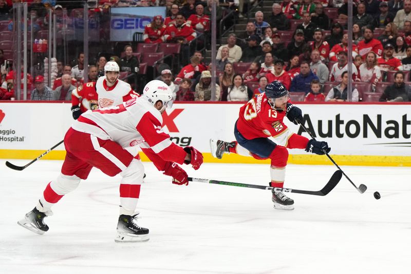 Jan 17, 2024; Sunrise, Florida, USA; Florida Panthers center Sam Reinhart (13) shoots the puck to score a goal against the Detroit Red Wings during the second period at Amerant Bank Arena. Mandatory Credit: Jasen Vinlove-USA TODAY Sports