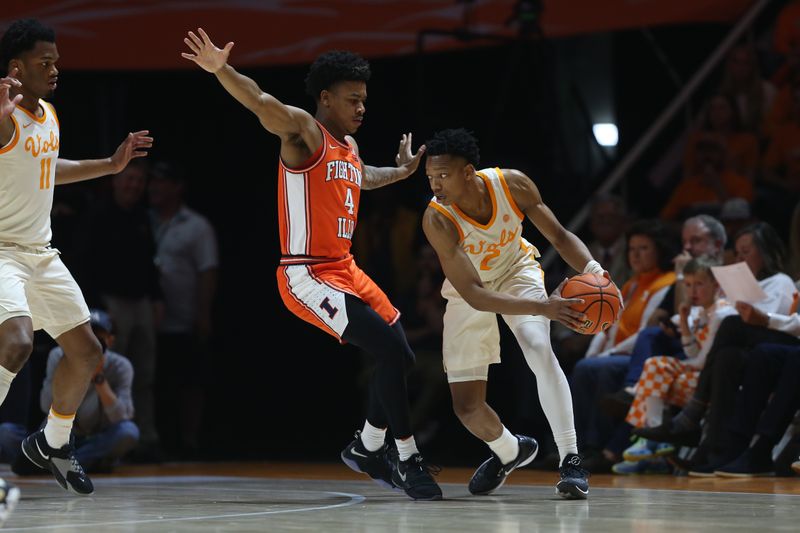 Dec 9, 2023; Knoxville, Tennessee, USA; Tennessee Volunteers guard Jordan Gainey (2) controls the ball against Illinois Fighting Illini guard Justin Harmon (4) during the first half at Food City Center at Thompson Boling Arena. Mandatory Credit: Randy Sartin-USA TODAY Sports