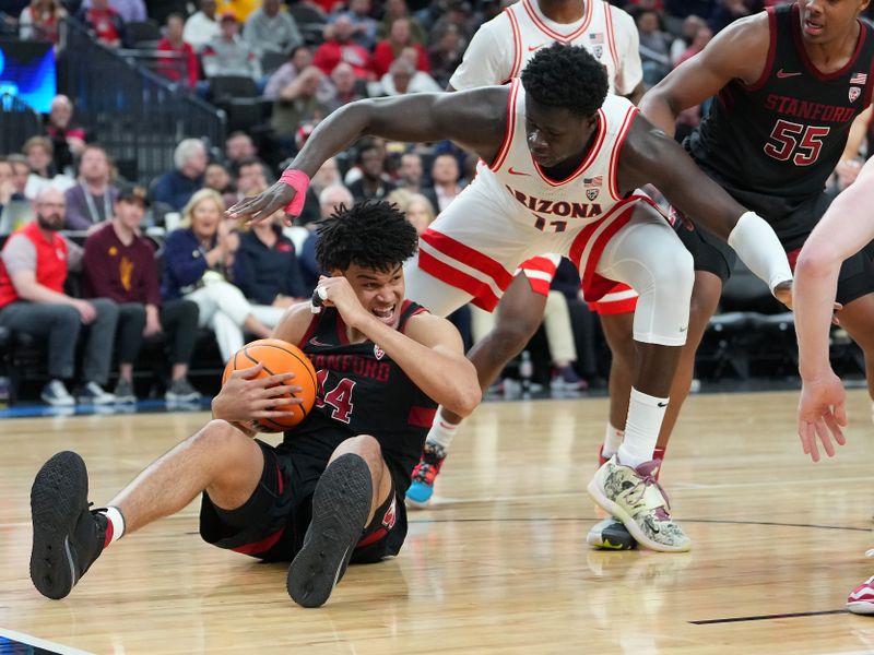 Mar 9, 2023; Las Vegas, NV, USA; Stanford Cardinal forward Spencer Jones (14) protects the ball from Arizona Wildcats center Oumar Ballo (11) during the second half at T-Mobile Arena. Mandatory Credit: Stephen R. Sylvanie-USA TODAY Sports